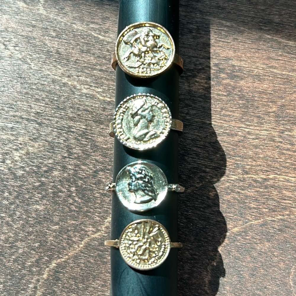 Four gold tone, coin style rings